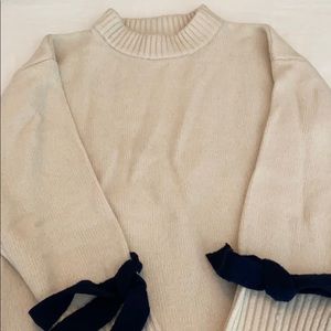 Cream tunic with navy detail at cuff and hem